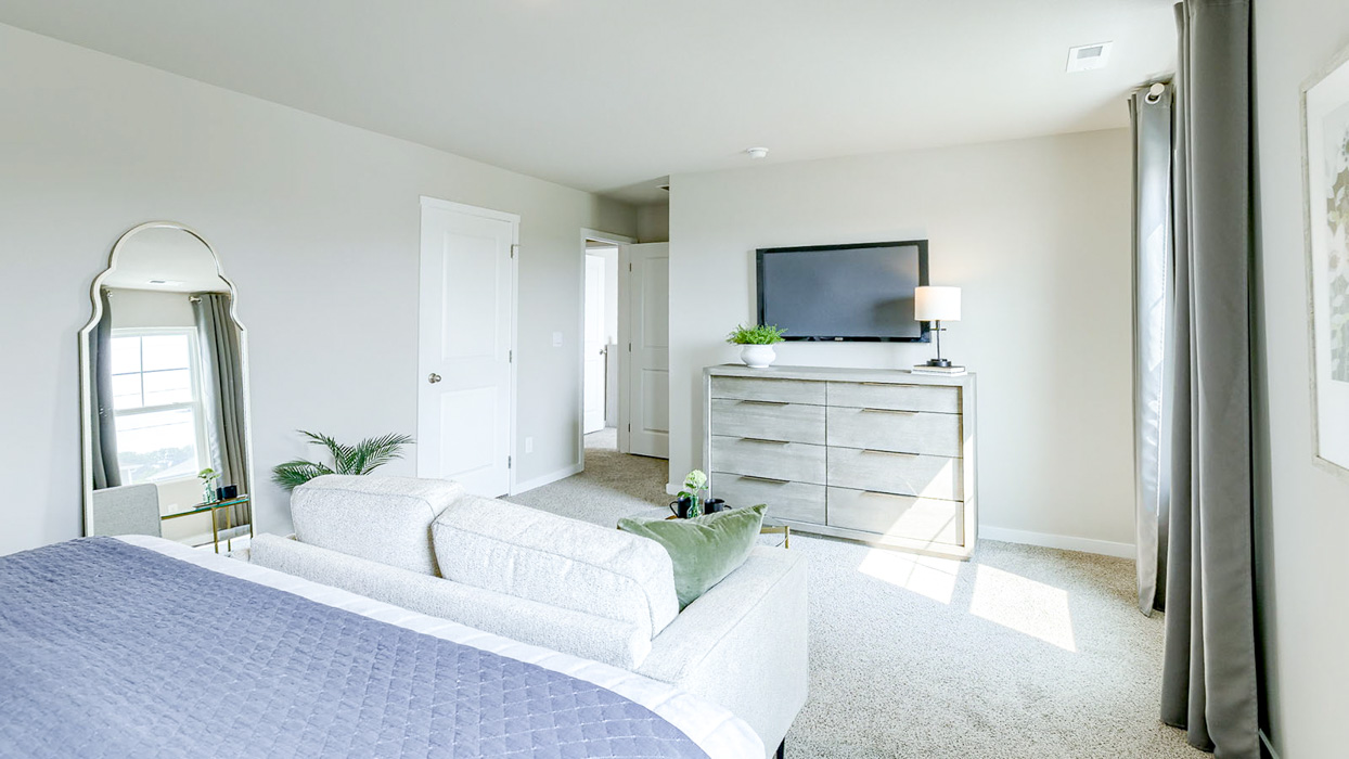 Bellhaven primary bedroom showing seating area and primary closet