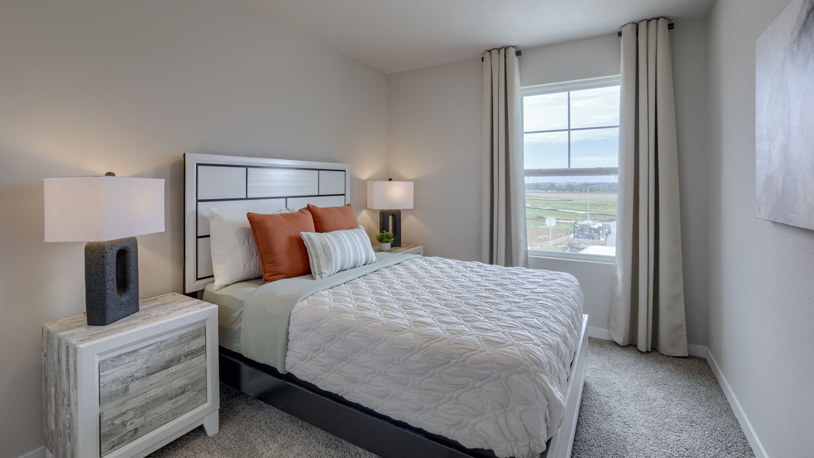 bedroom with beige carpet, beige walls and a window