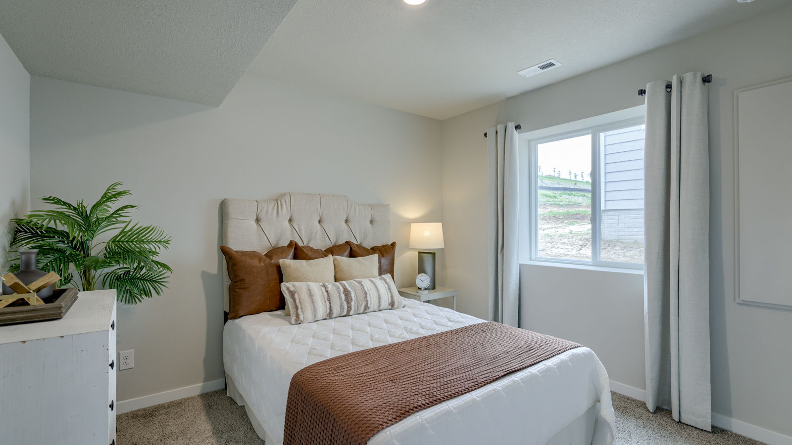 bedroom with beige carpet, beige walls and a window