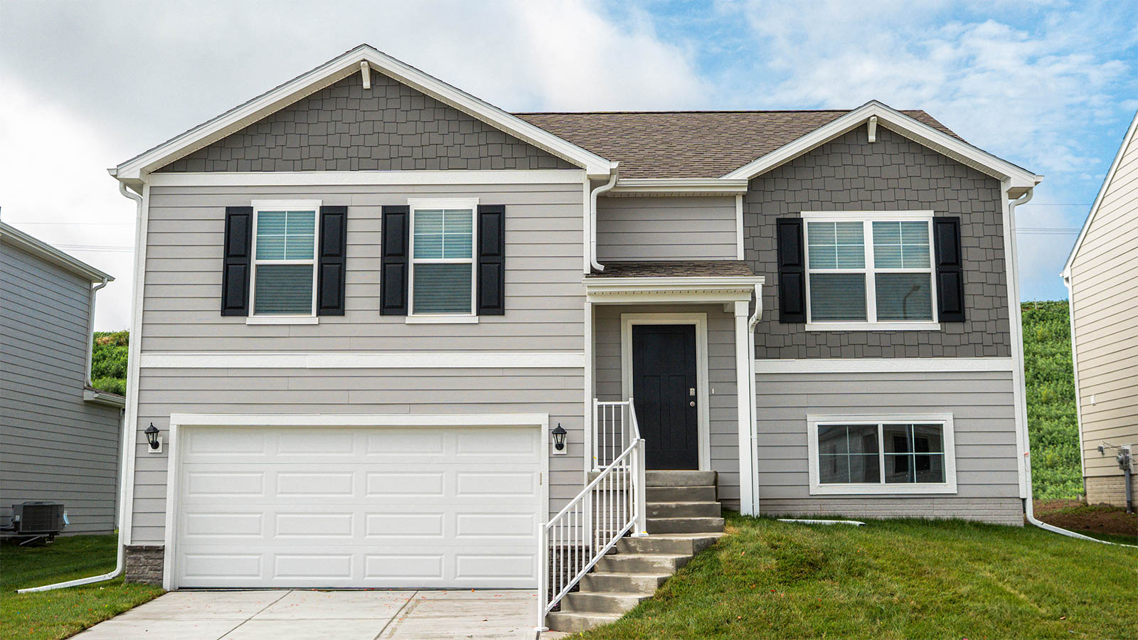 Exterior of split level fremont floor plan, 2 car garage and grey siding