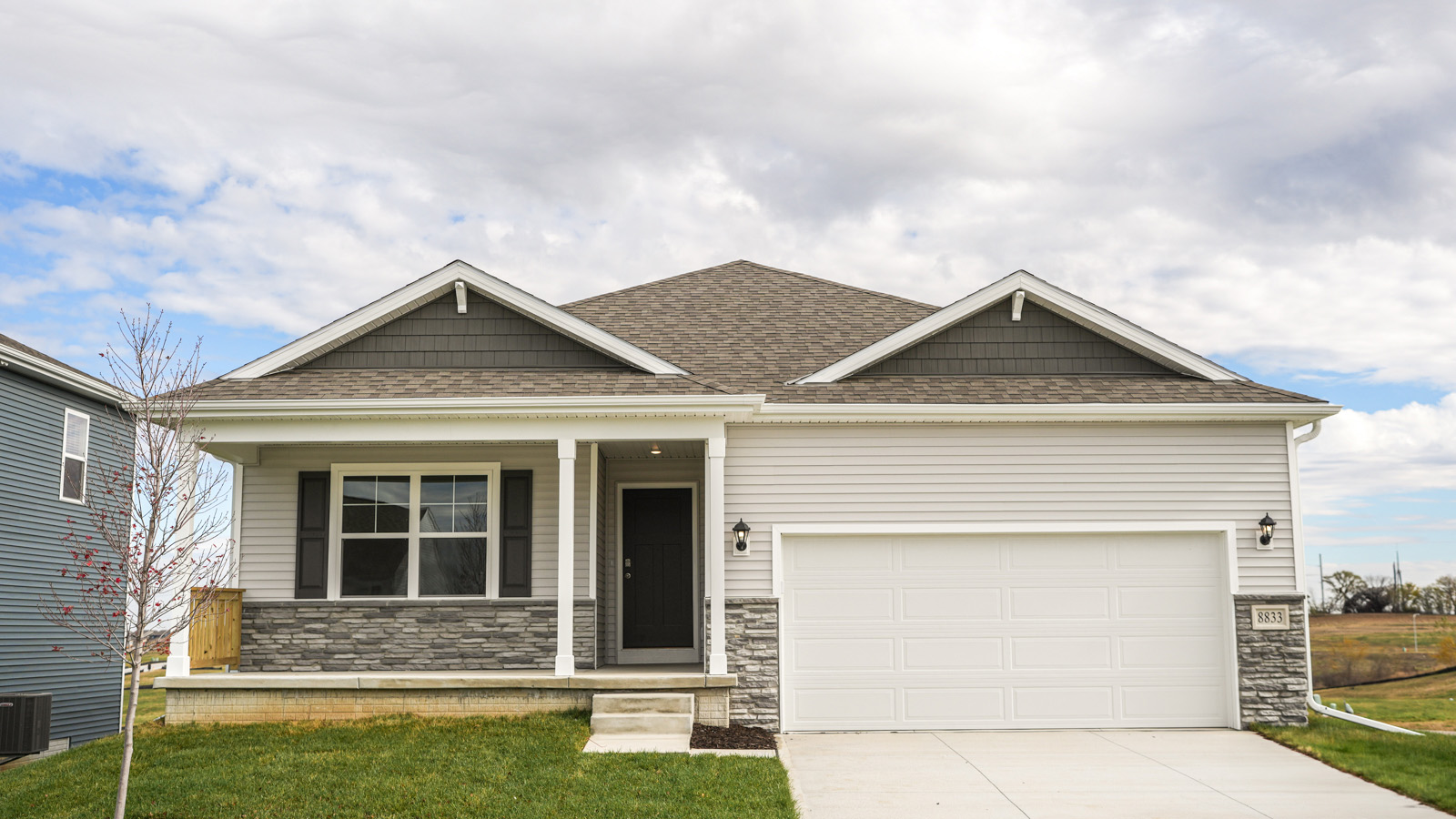 Exterior of Hamilton with covered front porch, 2 car garage, and Grey siding