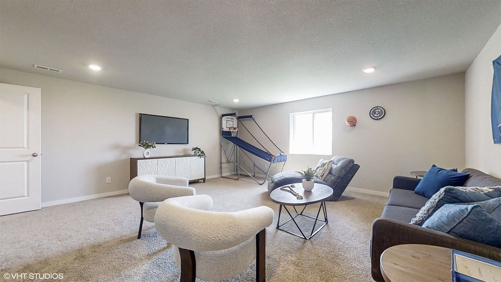 Finished basement living room of the Hamilton with seating a tv and entertainment area