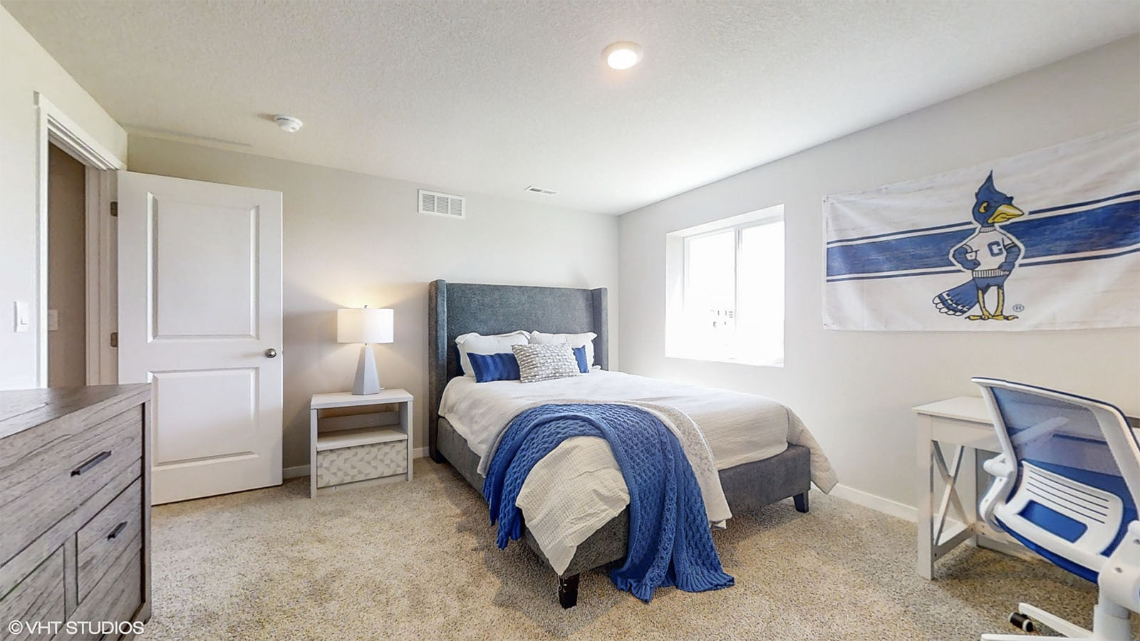 Fourth bedroom in the Hamilton finished basement staged with a sports theme