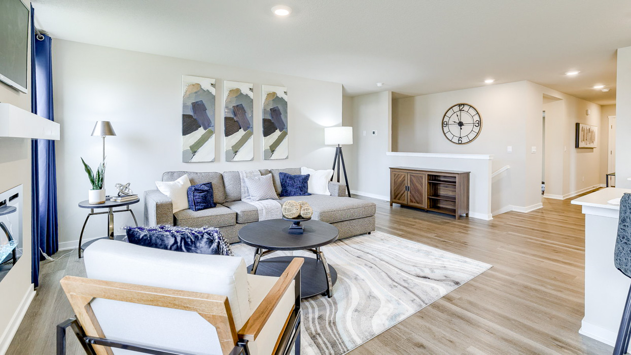 Living room in the Hamilton with couch and a chair around a coffee table