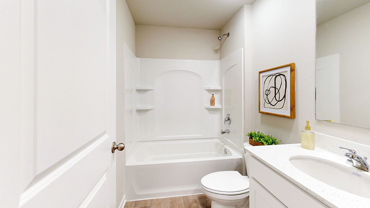 Second bathroom in the roland with bathtub and toilet and sink