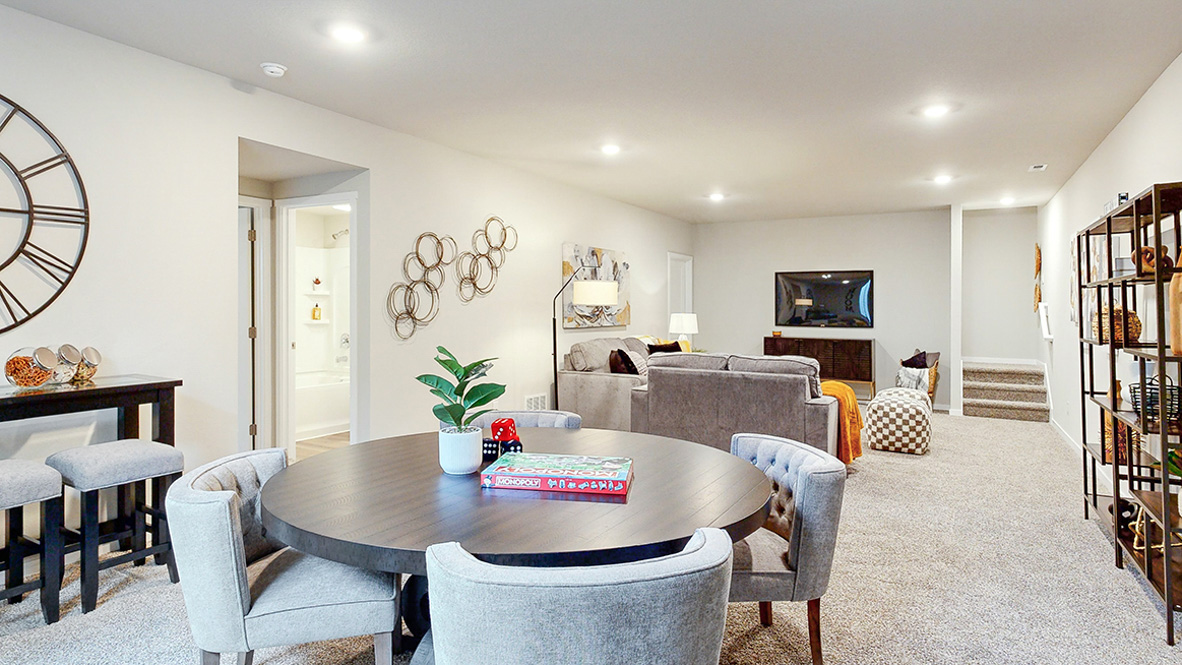Finished basement in the Roland with a game table and large tv area