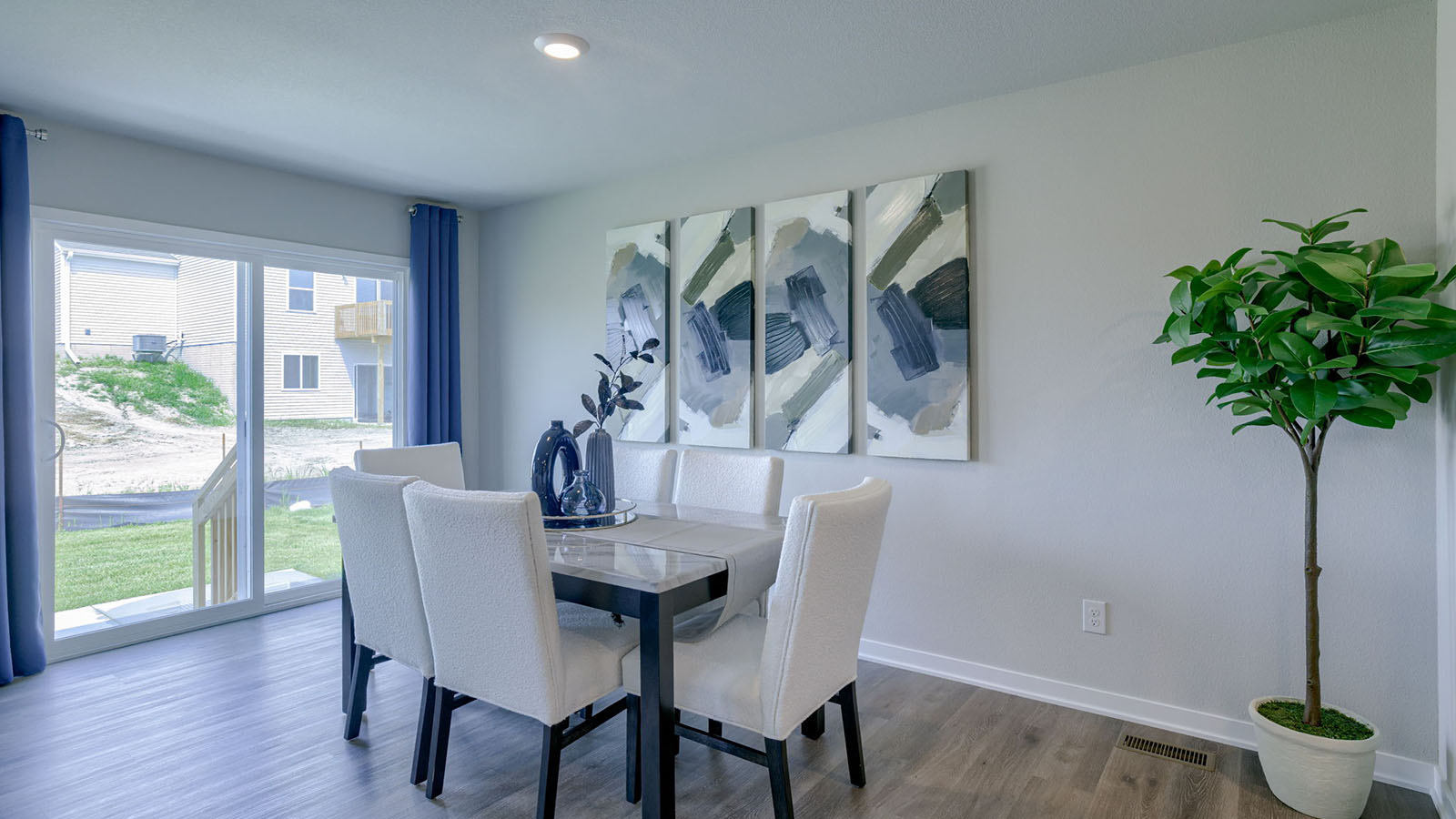 Roland dining room with a long table with 6 chairs and a sliding glass door