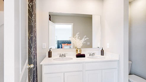 Primary bathroom with white cabinets