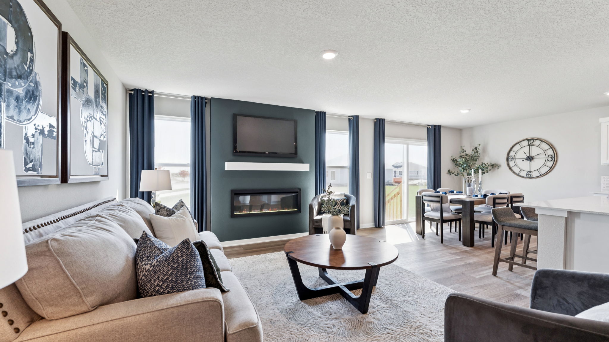 Overview of Hamilton living room and dining room with electric fireplace.