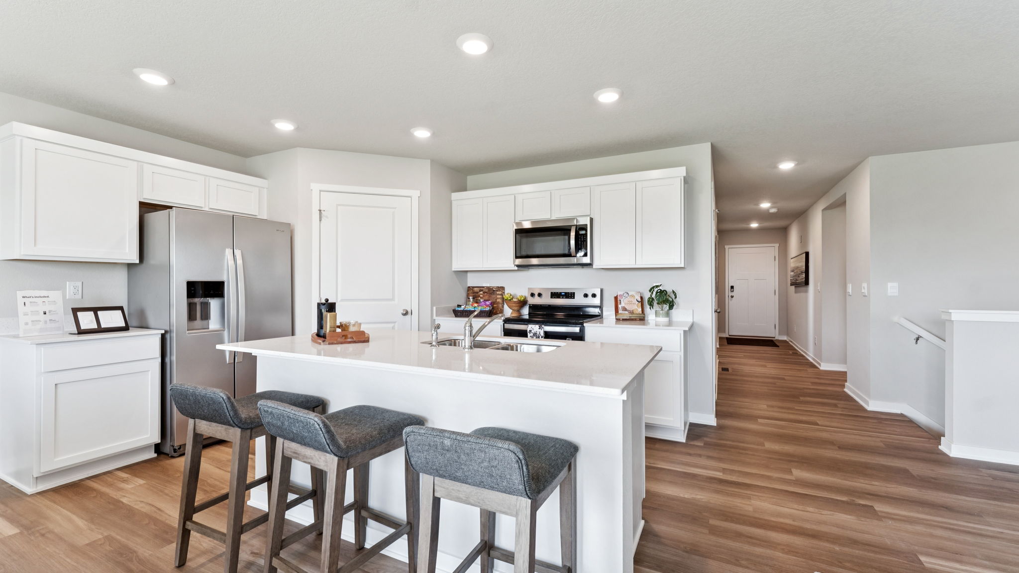 Kitchen of Hamilton with white cabinetry and Large Island with white quartz counters