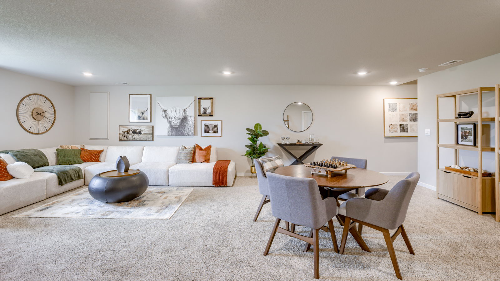 Overview of basement living area in Neuville with large sectional couch and window for natural light