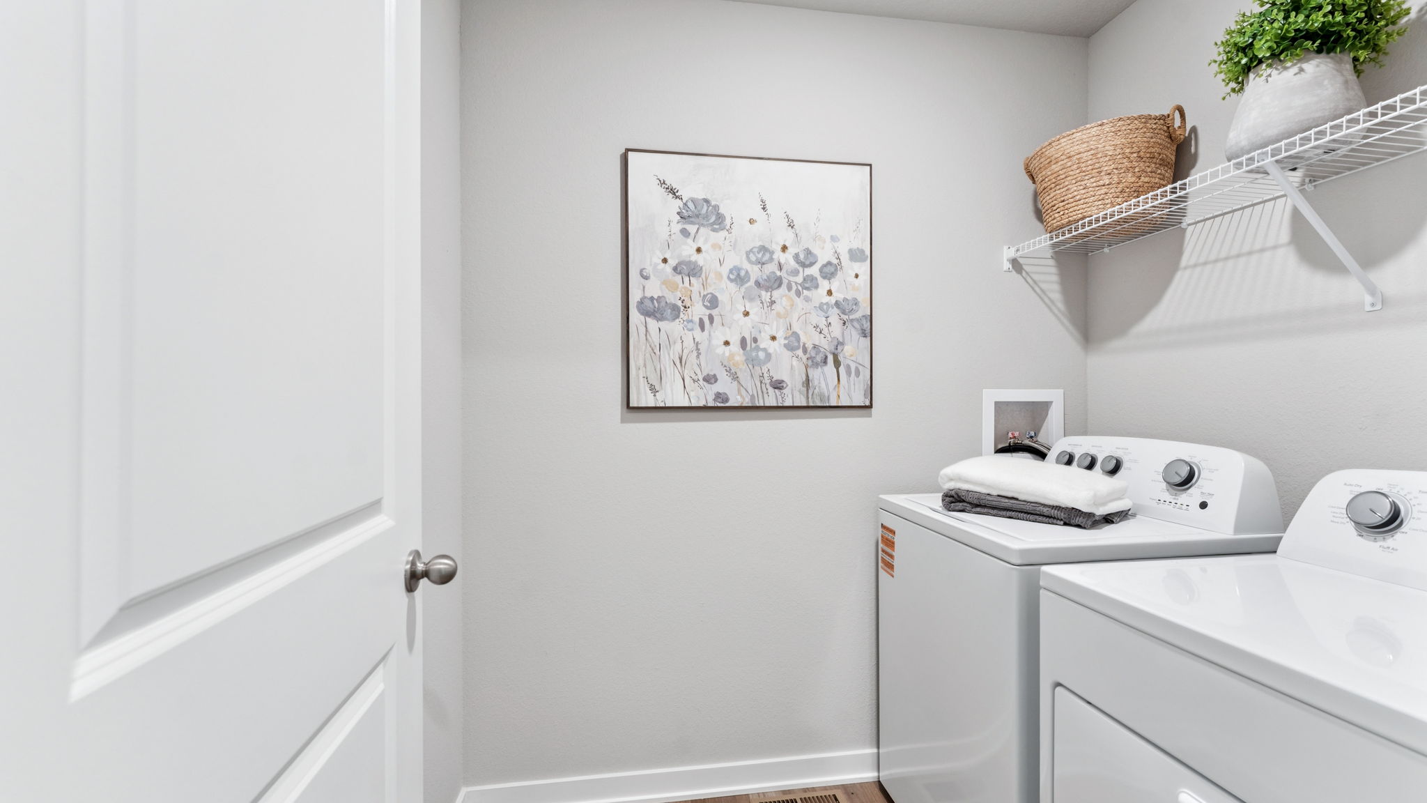 Laundry room with wire shelves above