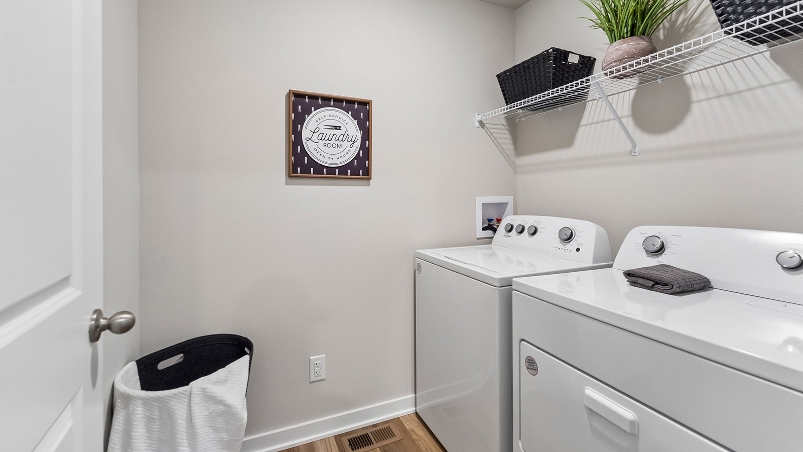 Hamilton laundry room with shelf and clothes hamper