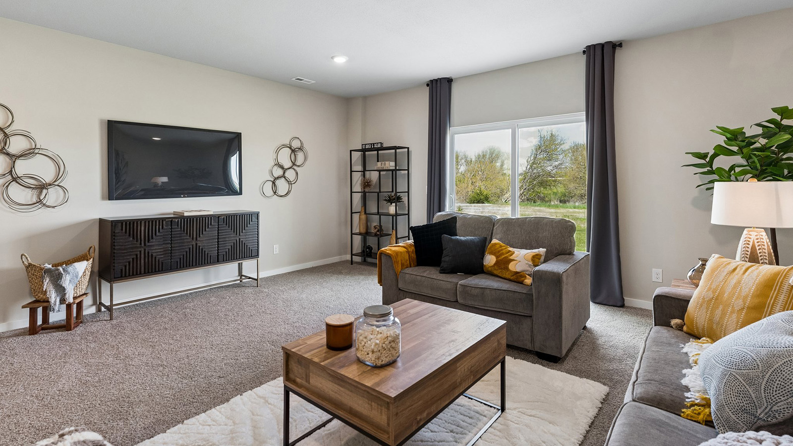 Hamilton finished basement living room with sliding glass doors leading to the backyard