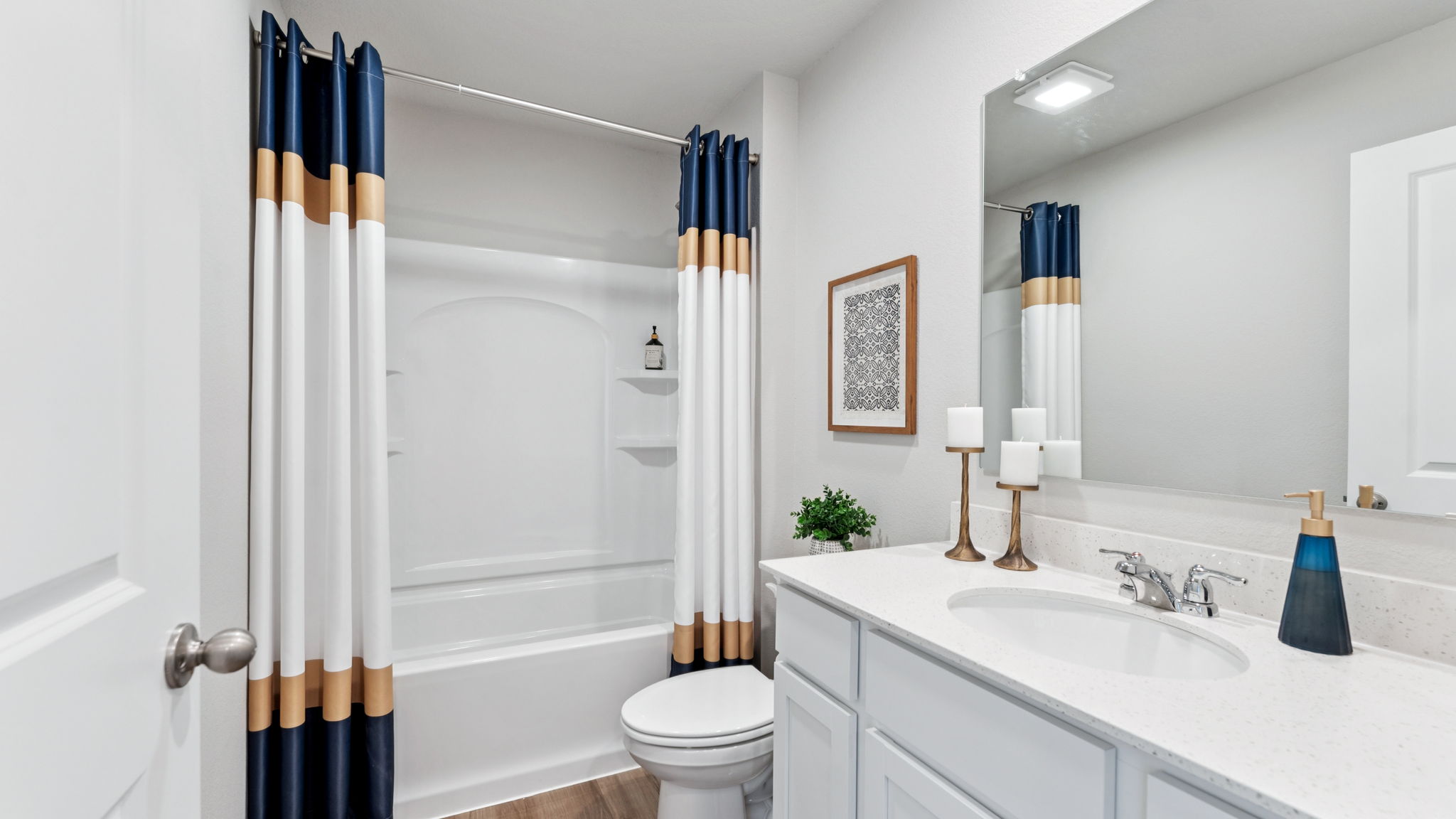 Upstiars bathroom of the Hamilton with a tub shower and large vanity