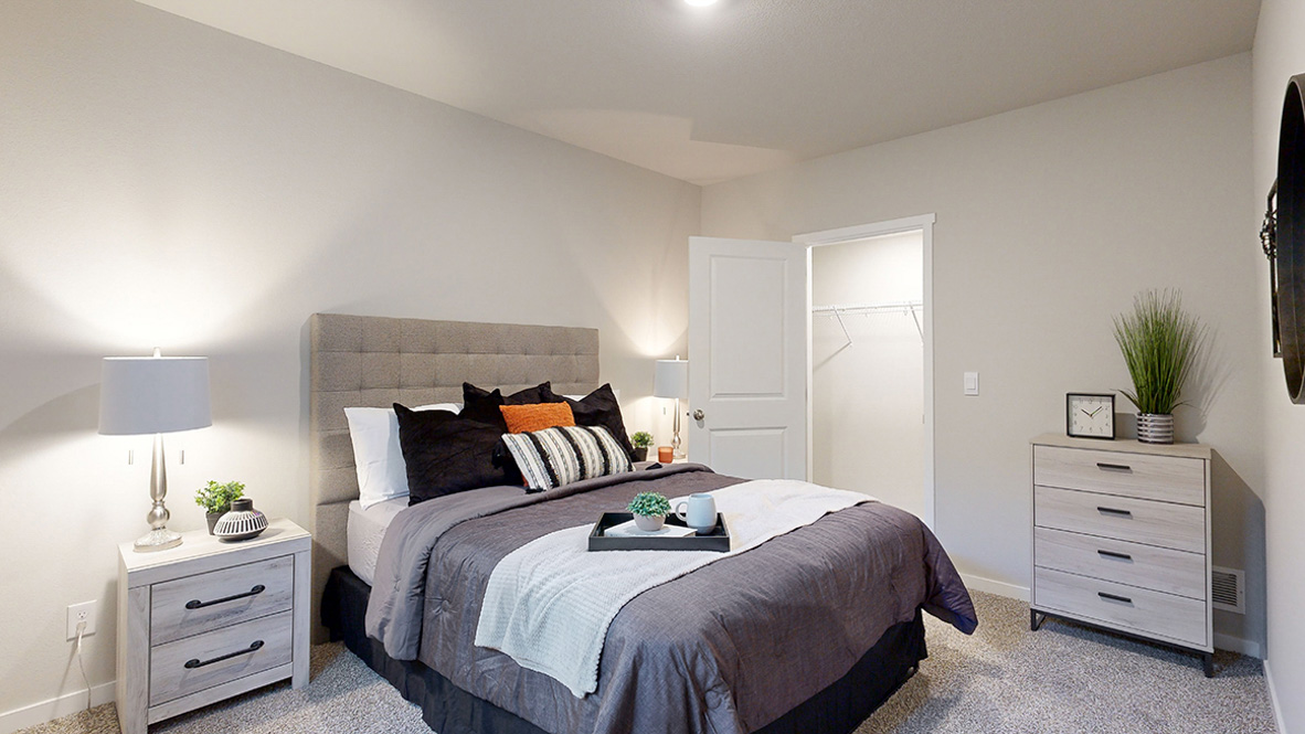 Fifth bedroom in Bellhaven finished basement with queen bed nightstand and dresser
