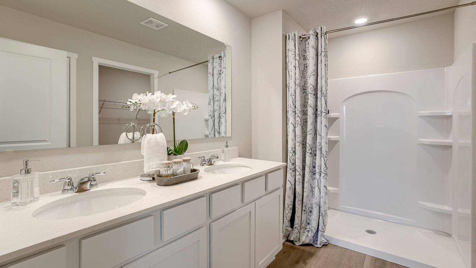 Primary bathroom with two sinks and shower