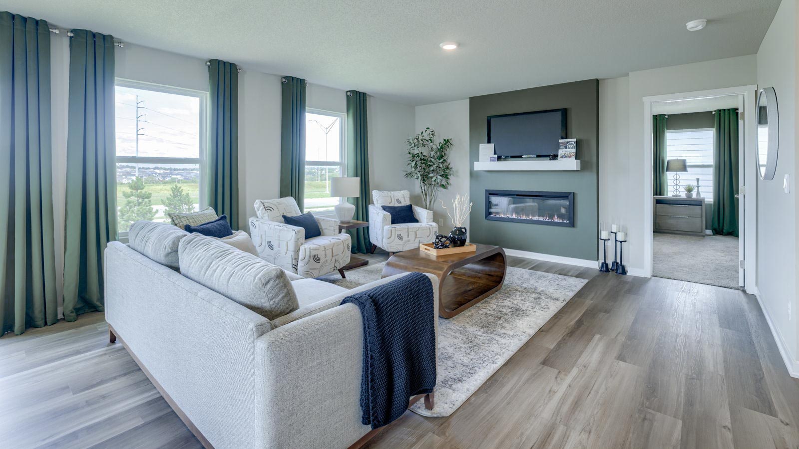 Neuville living room with entrance to masterbedroom
