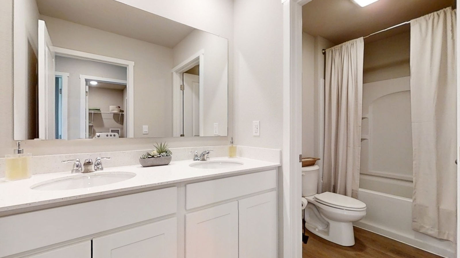 Second full bath in the Emerson with dual sinks and a seprate toilet and bathtub area