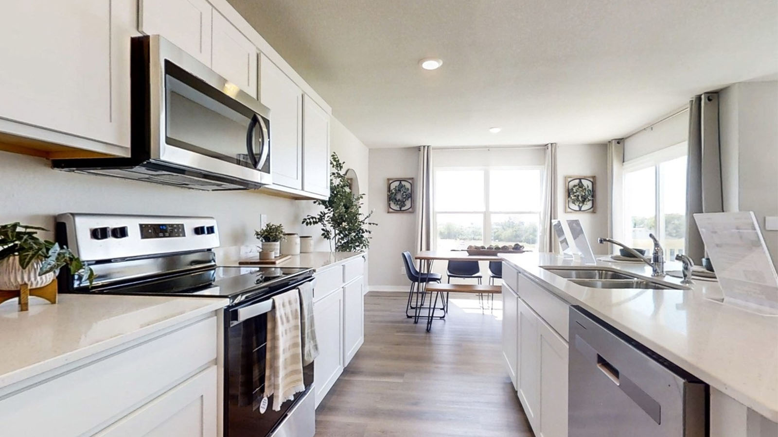kitchen of the Emerson showing the stainless-steal appliances and looking into the dining room