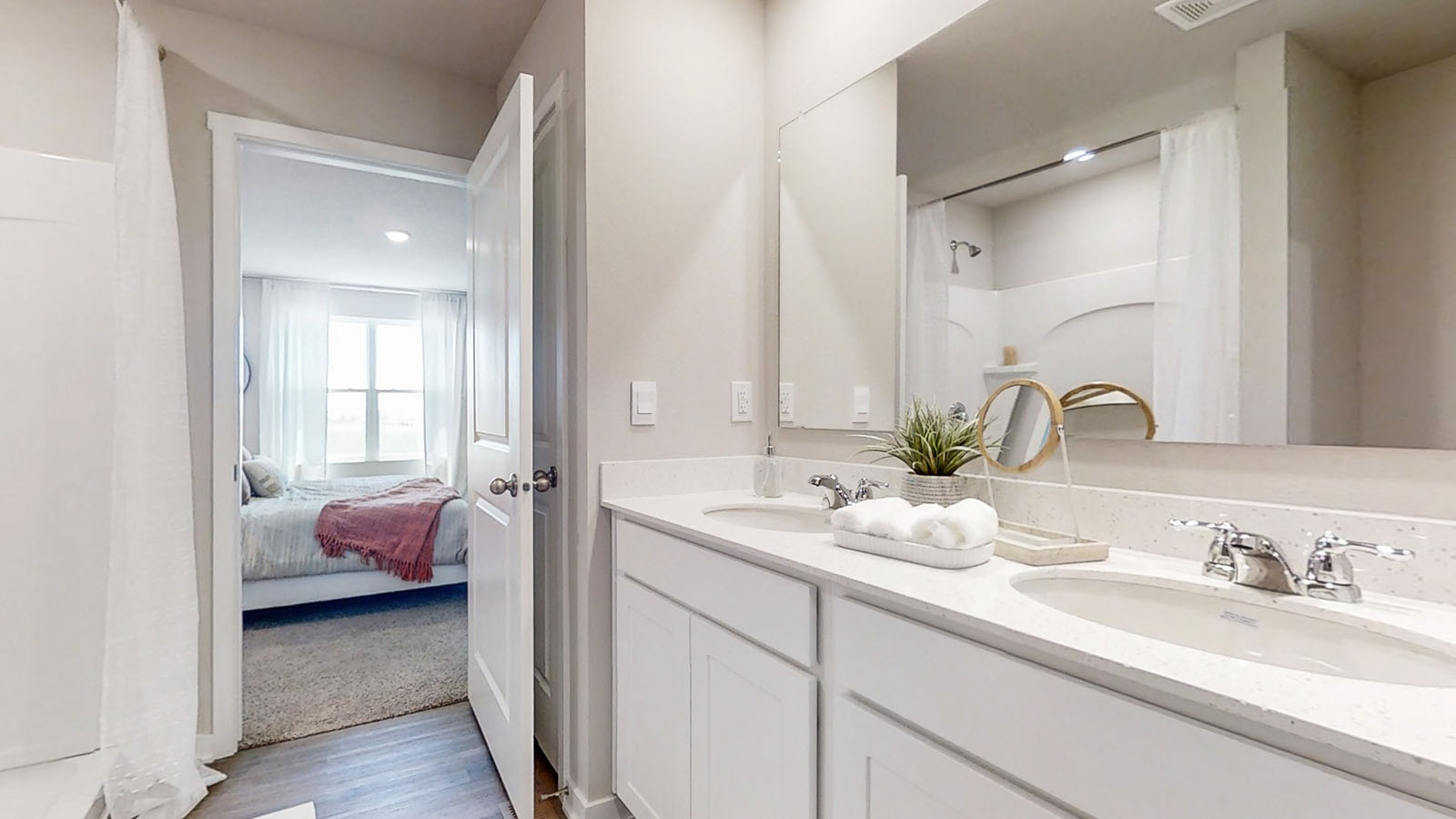 Hamilton primary bathroom with dual sink vanity quartz countertops and a walk in shower