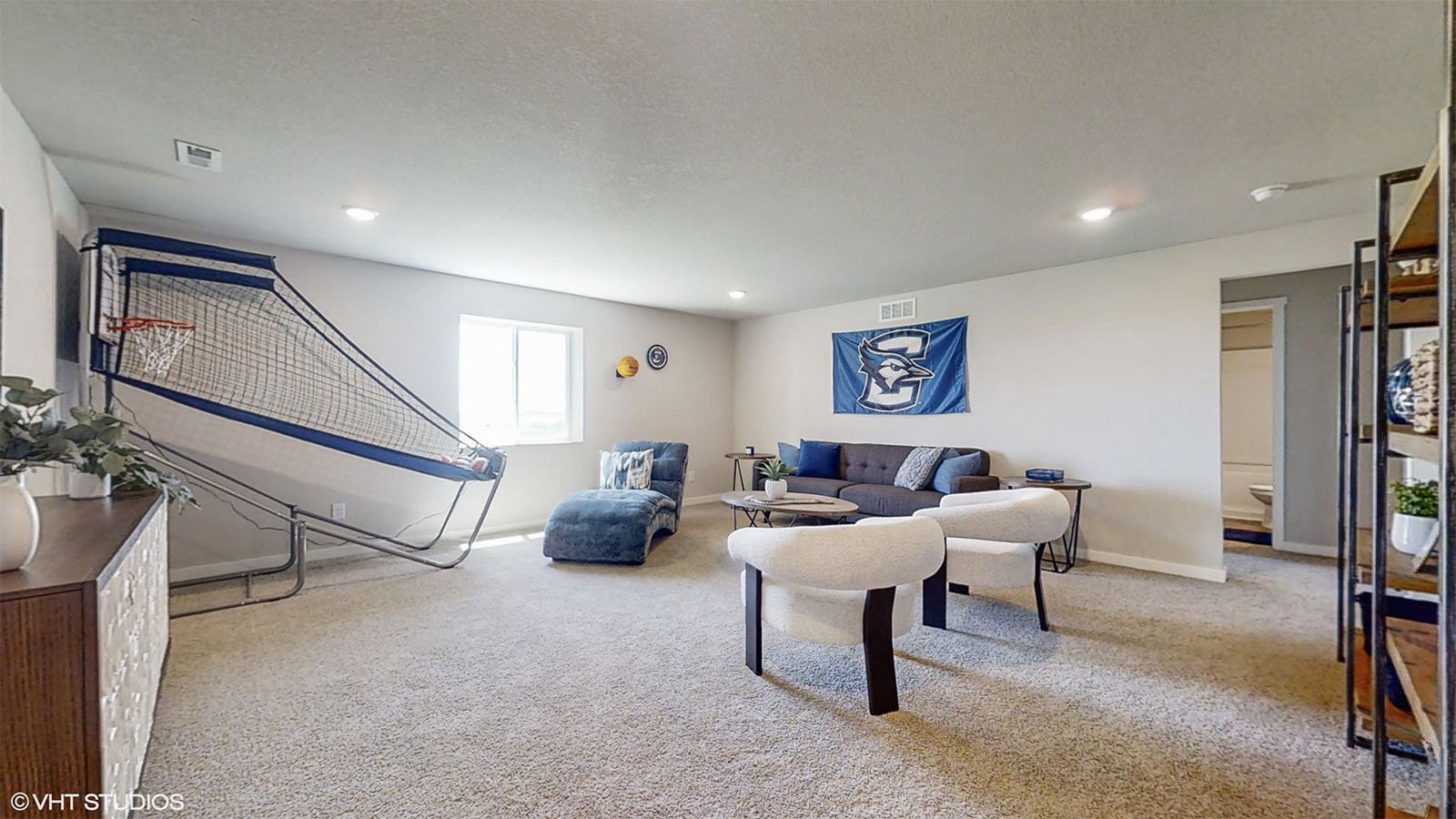 Hamilton finished basement with a seating area and basketball net