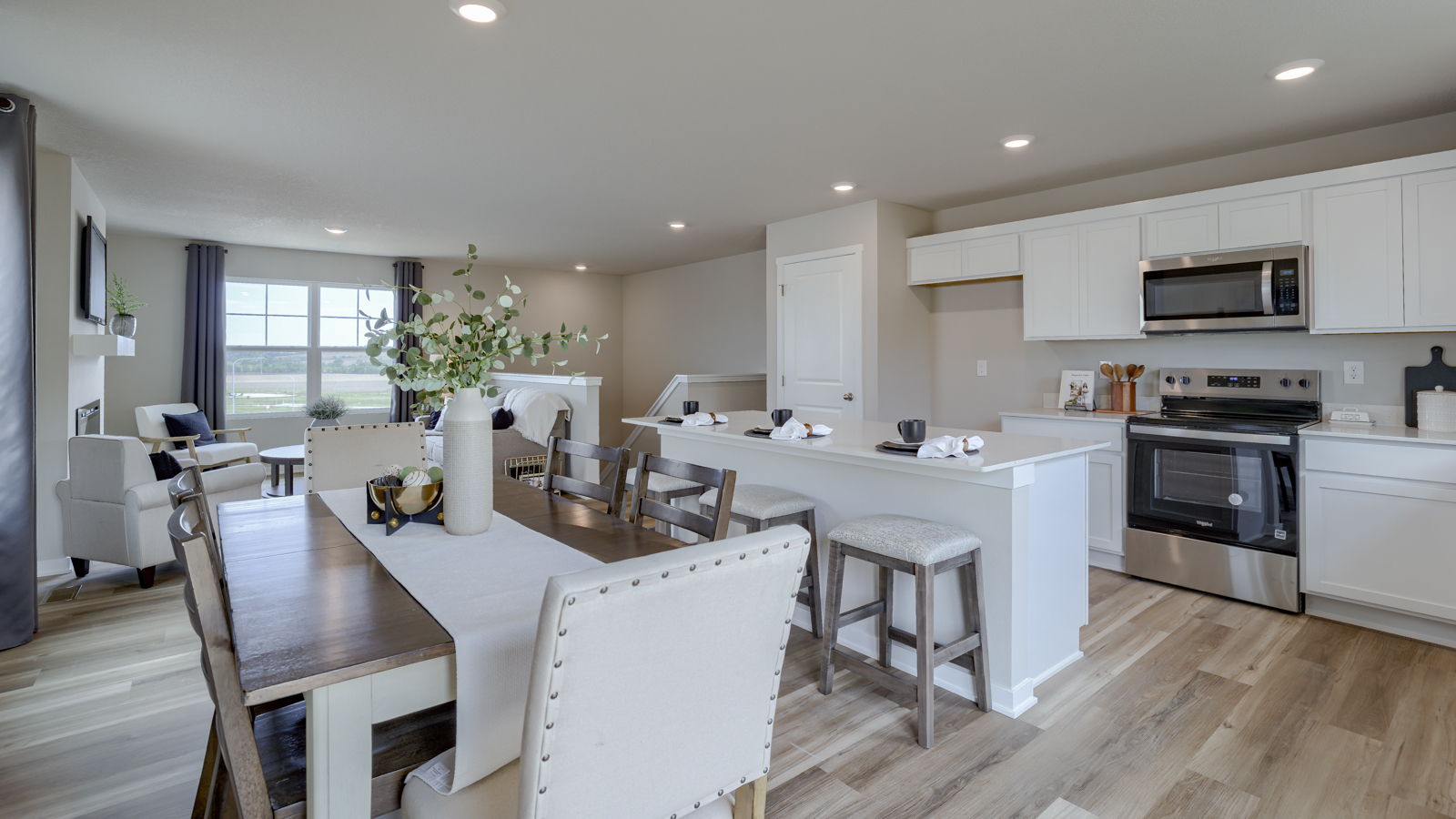 View from entry to kitchen with island, new appliance suite included, pantry and cabinet selections