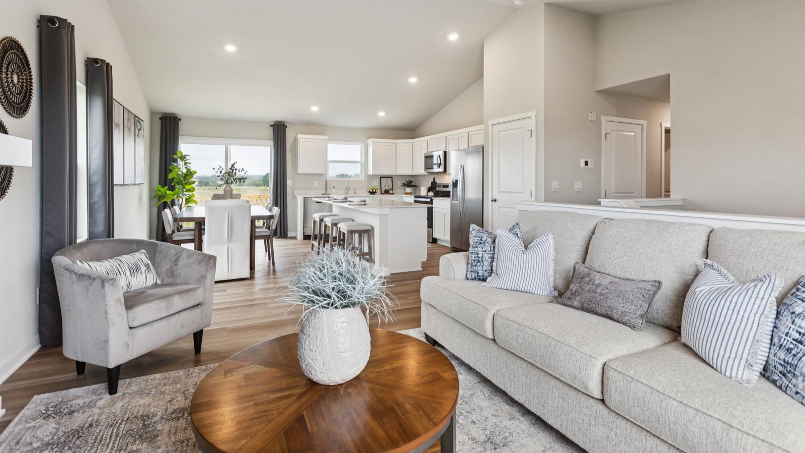 Living room with views into dining, kitchen, and outside access brings flow to your home adding connectivity