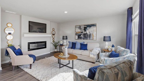 Living room of the holland with a couch and 3 chairs around a coffee table