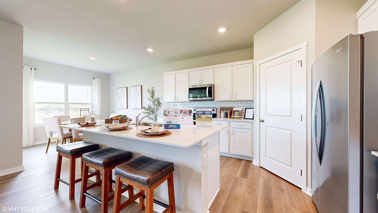 Fairfield kitchen with island and 3 chairs and overlooking into the dining room
