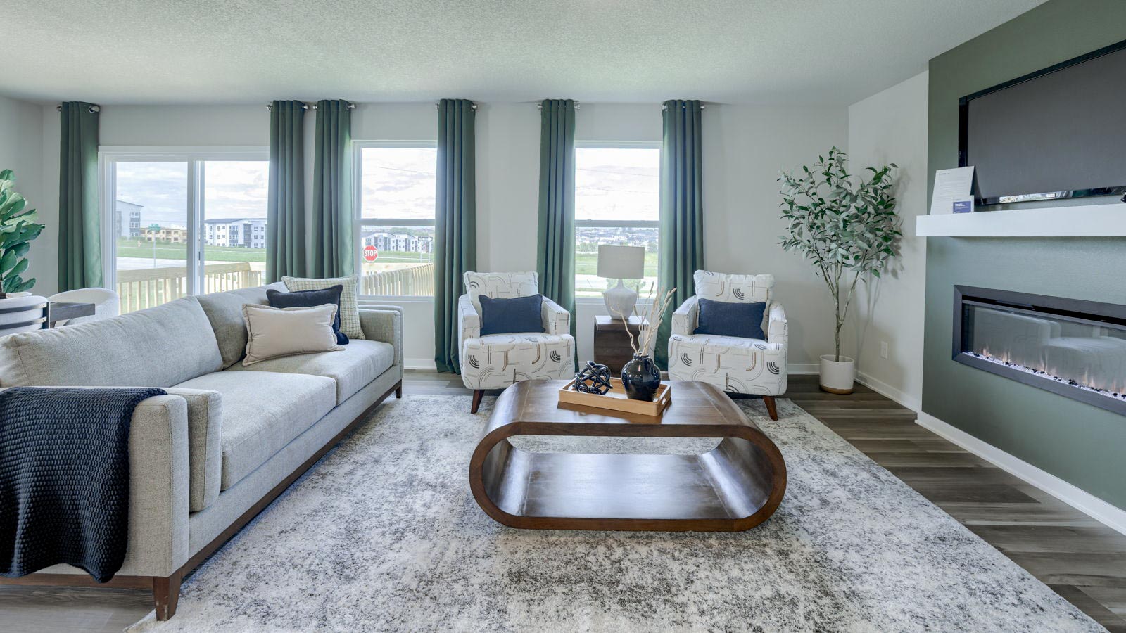 Main living area of the Neuville with a couch, coffee table, and 2 chairs for seating