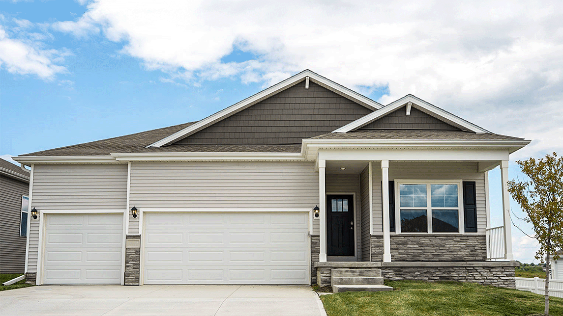 Exterior of the Fairfield plan, with beige two-toned siding, a covered front porch and 3 car garage.