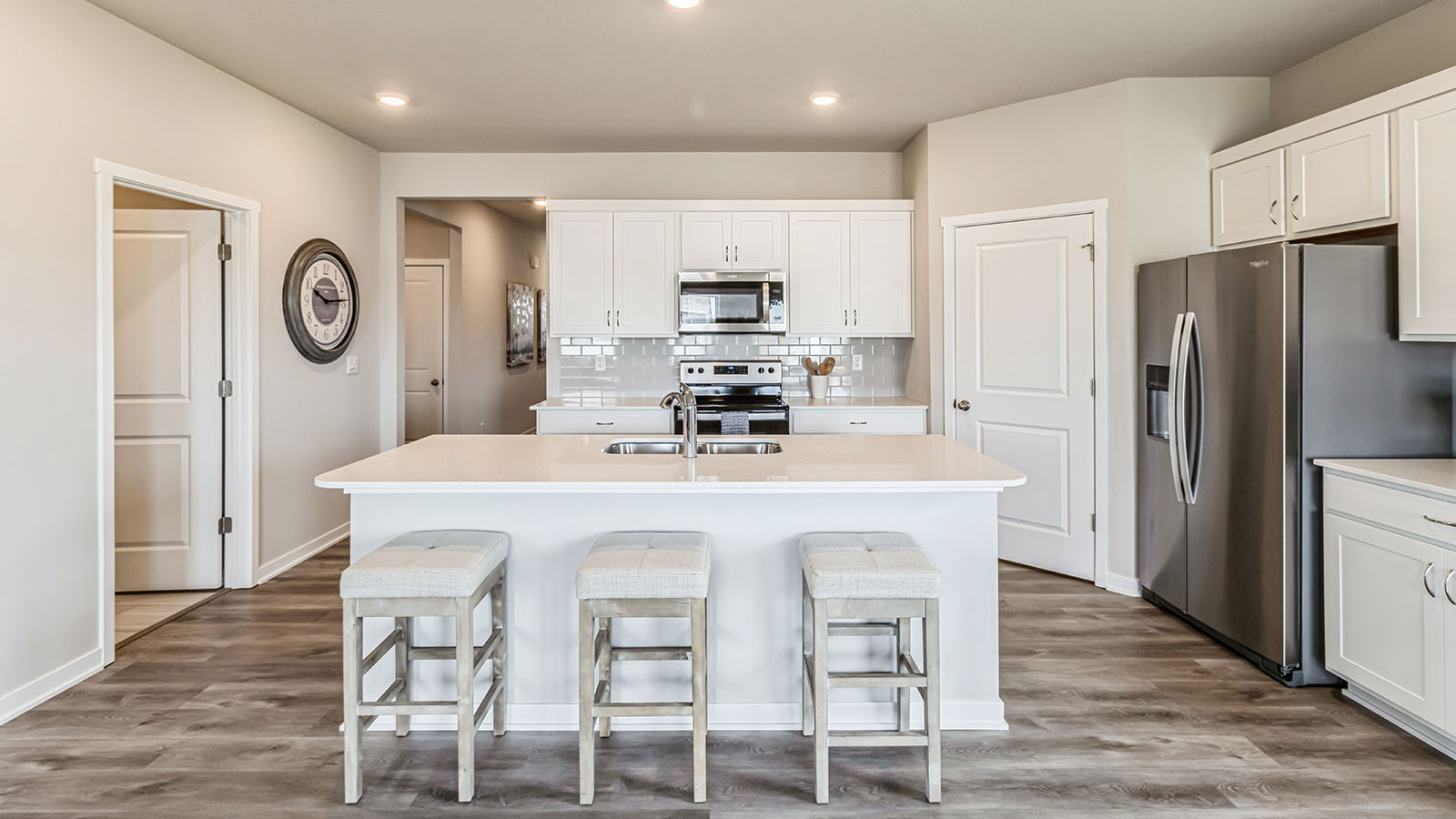 Kitchen with white quartz countertops.