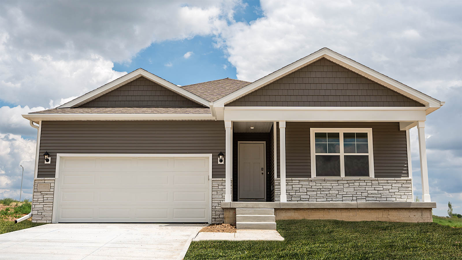 Front exterior of home with partial brick siding.