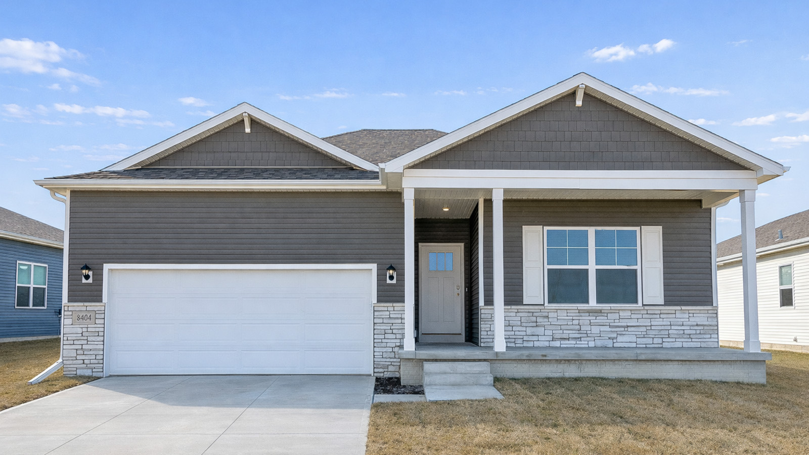 Front exterior of home with partial brick siding.