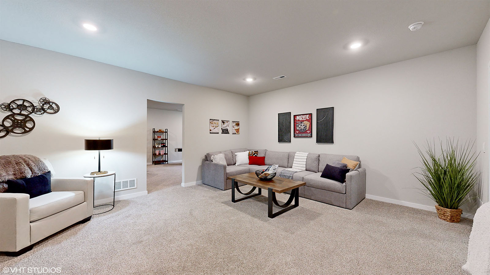 spacious finished basement of the Fairfield with a sectional and a coffee table