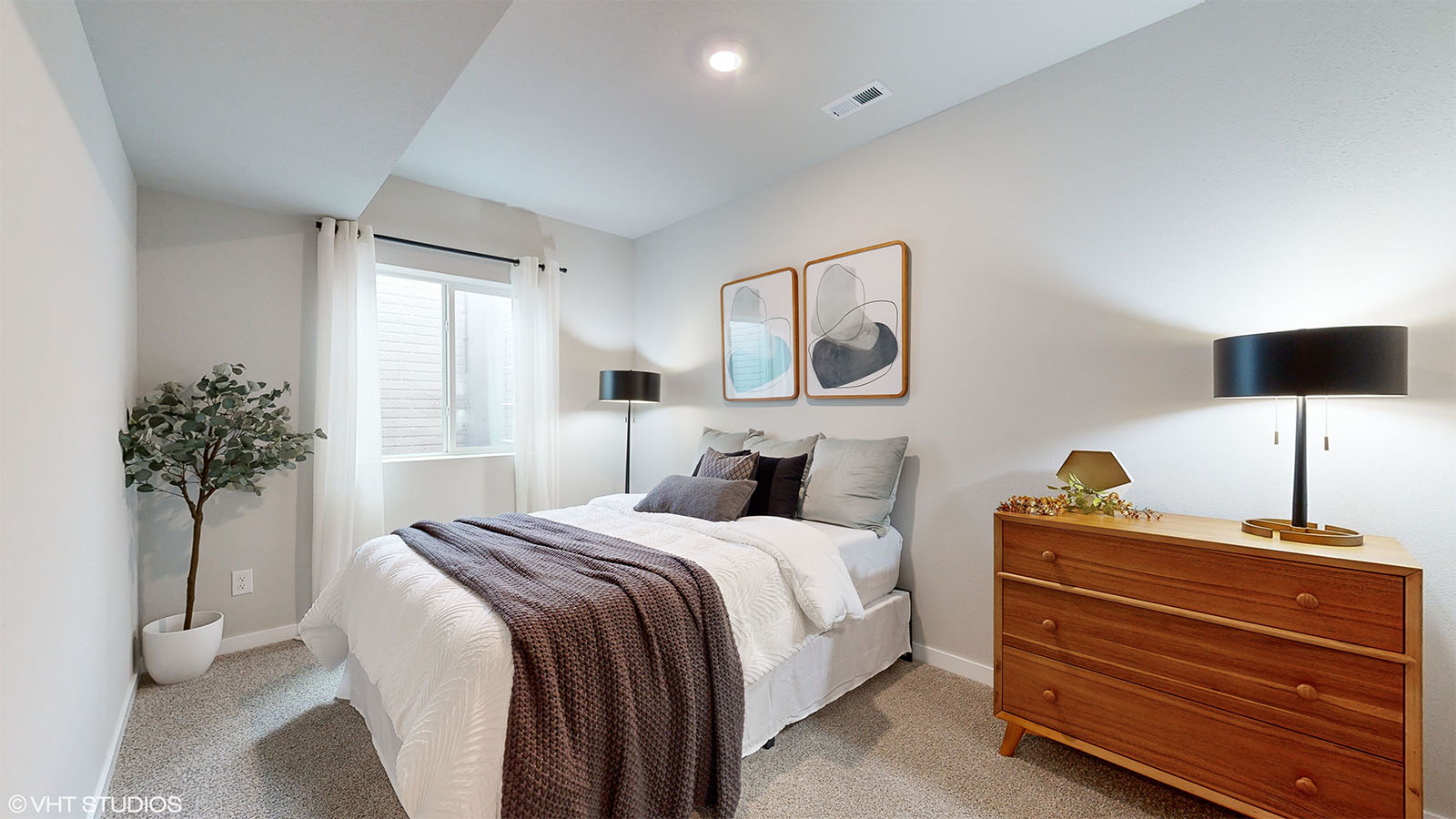 Fifth bedroom in the finished basement of the Fairfiled with a queen bed and dresser