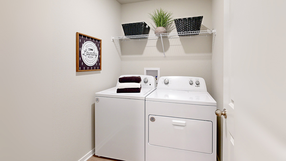 Roland laundry room with shelves