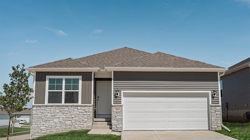 Exterior photo of the Roland with grey siding, stone and a 2 car garage