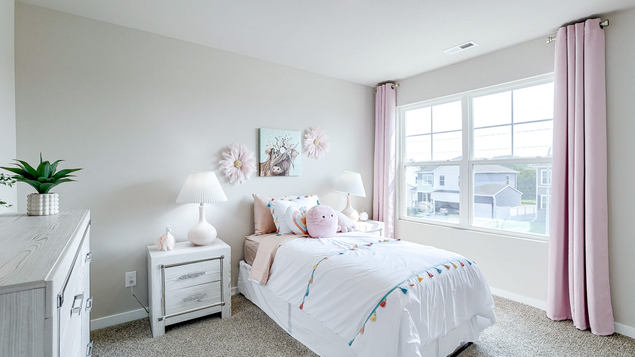 Second bedroom in the Bellhaven decorated with white and pink accents