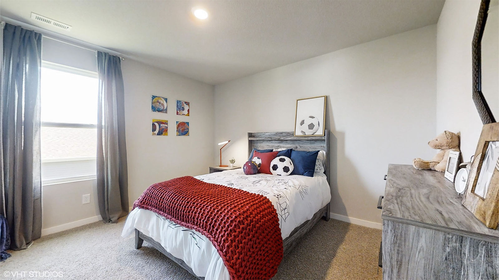 Fourth bedroom in the Bellhaven with large window full bed and dresser