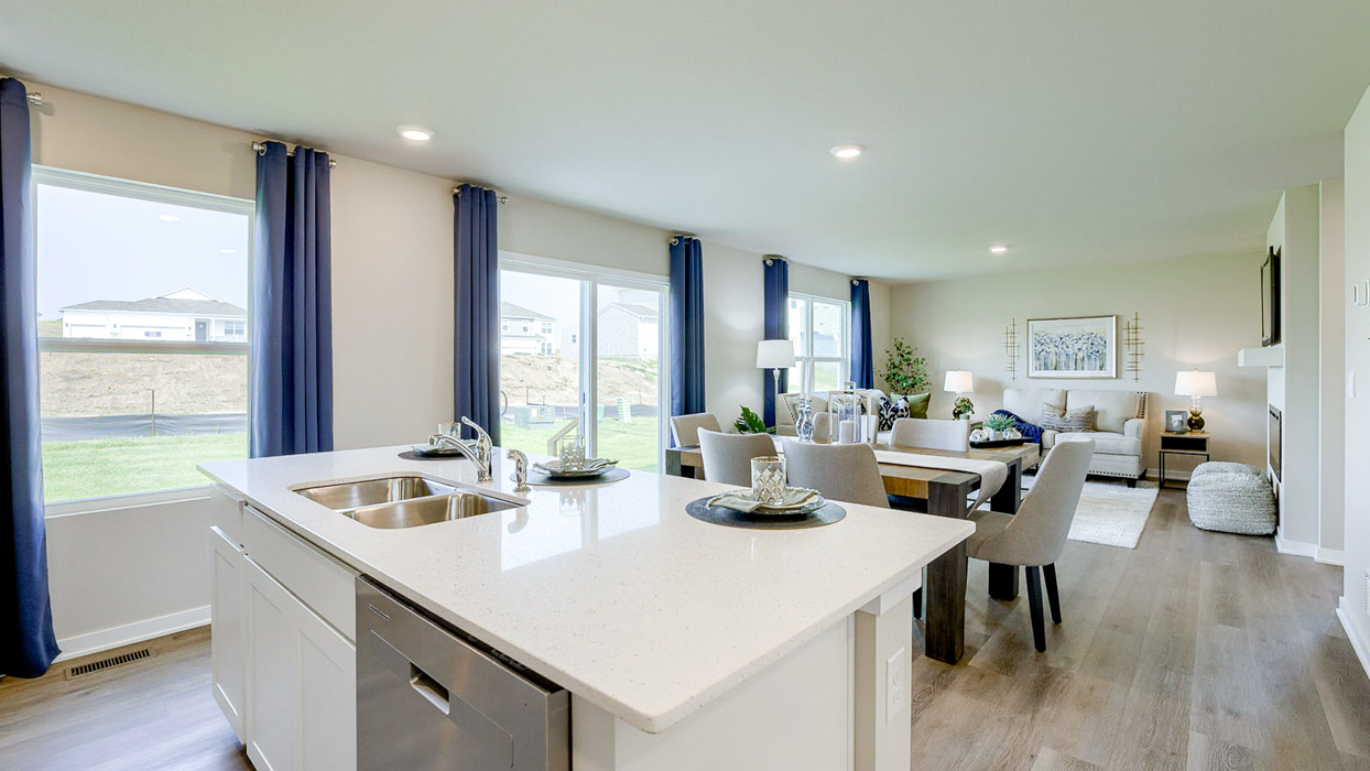 Bellhaven kitchen showcasing the living room and dining area with large windows