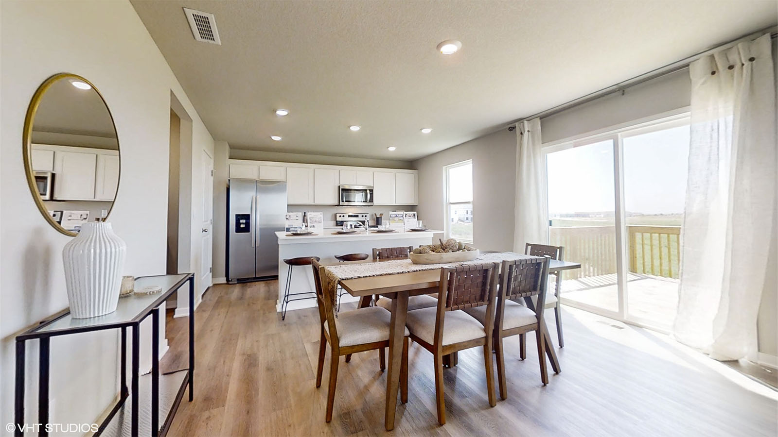 Dining area of the Bellhaven overlooking the kitchen with sliding glass doors