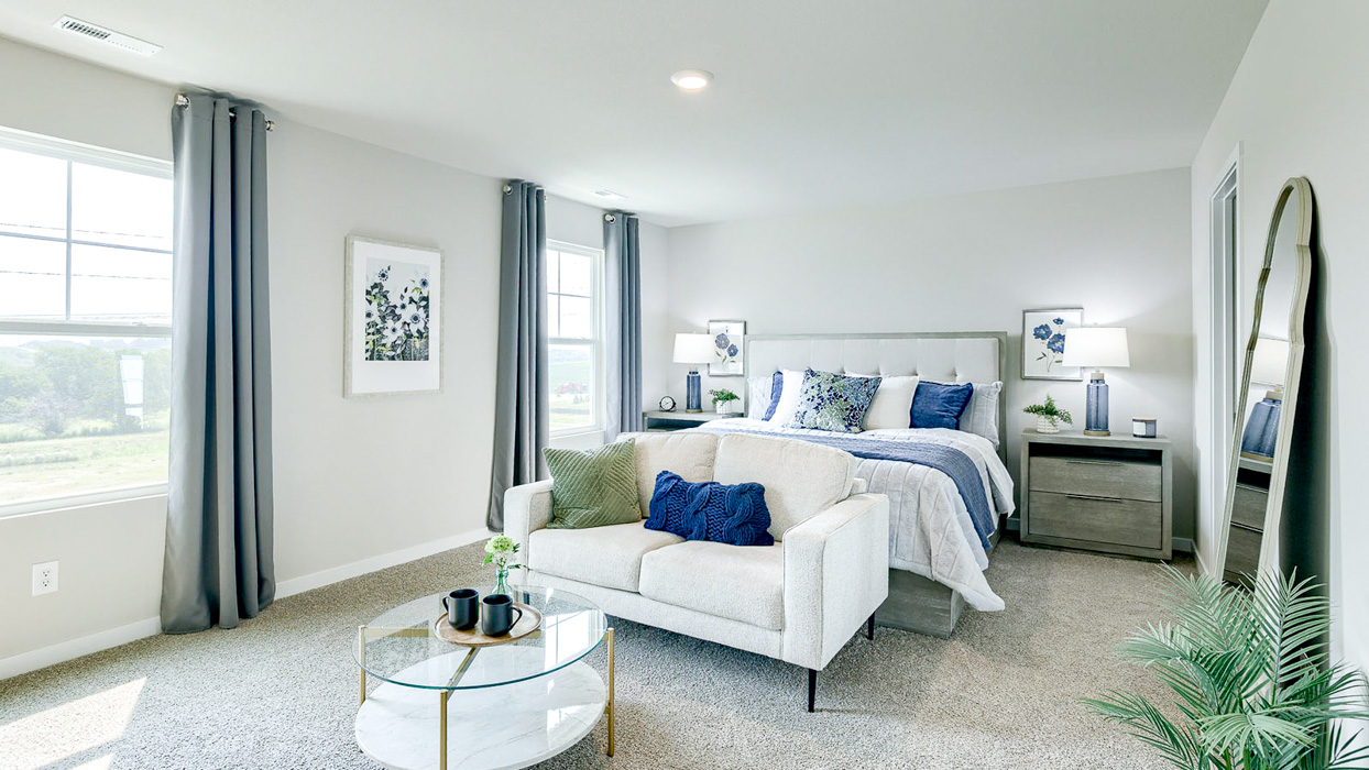 Large primary bedroom in the Bellhaven showing a sitting area