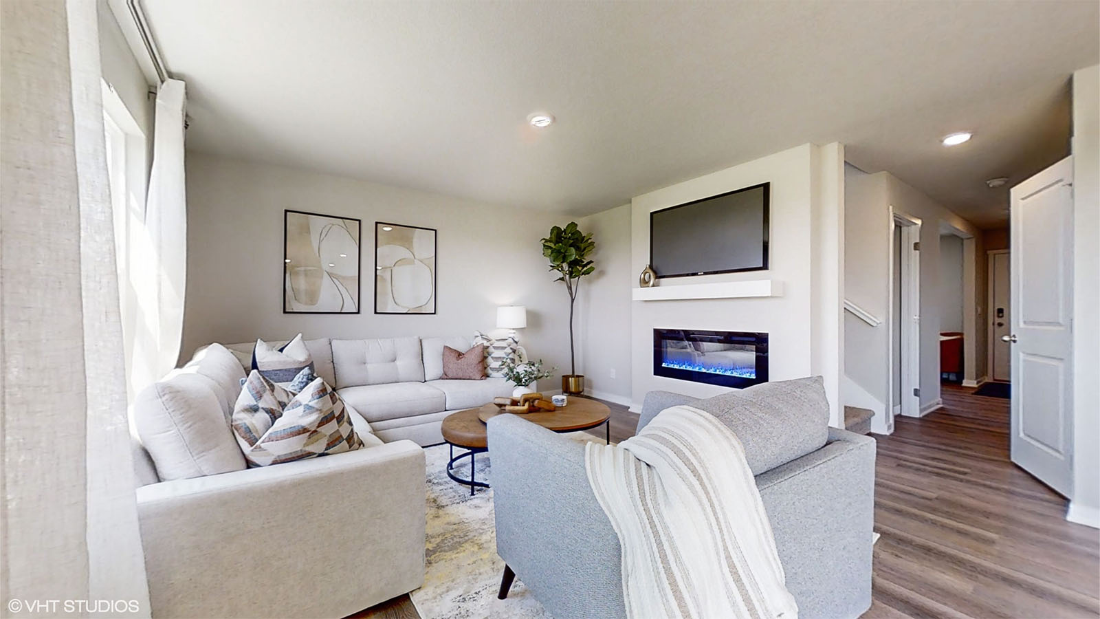 Bright living room showing the fireplace and front entrance of the Bellhaven