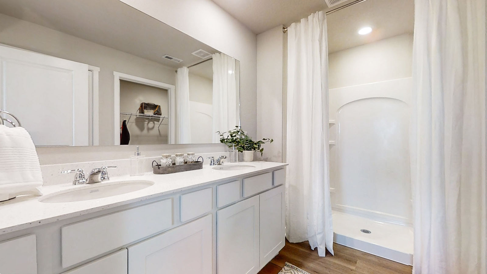 Primary bathroom with dual sinks and walk in shower