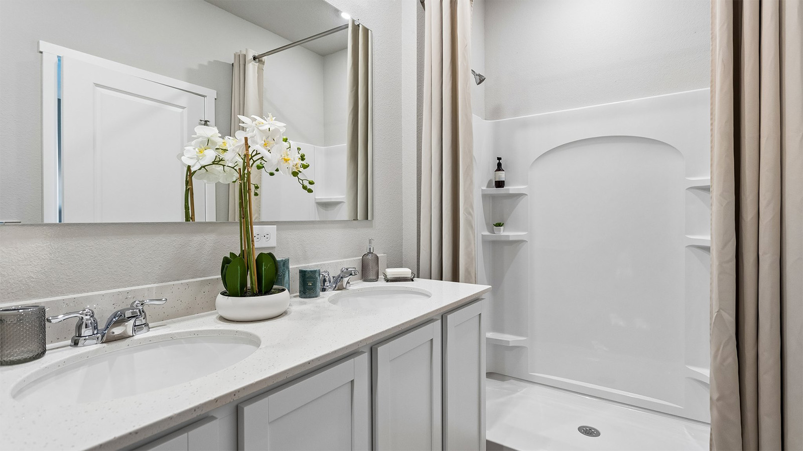Primary bathroom in the Abbott with dual sinks and walk-in shower