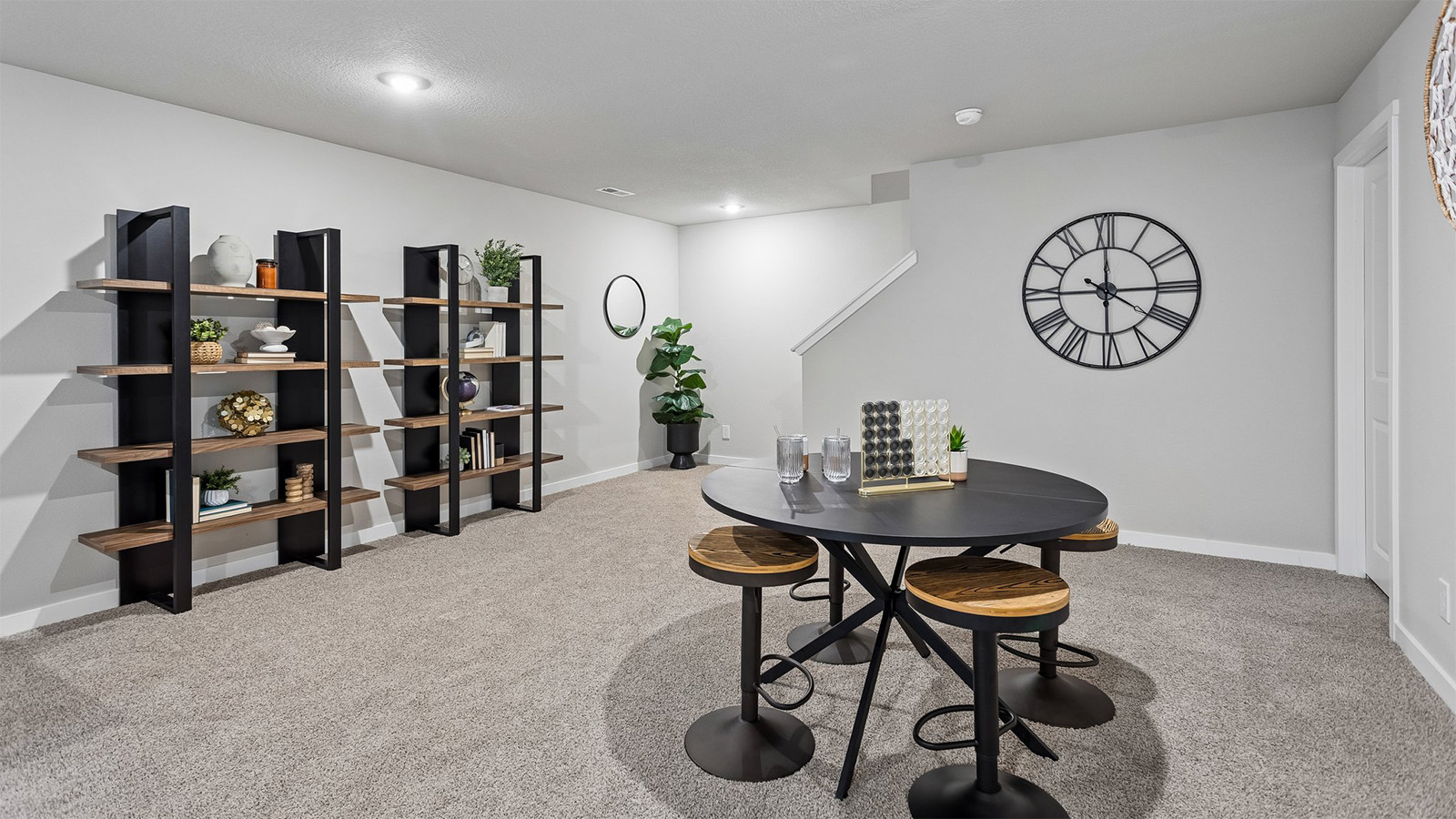 Abbott finished basement entertainment area with seating and large shelves