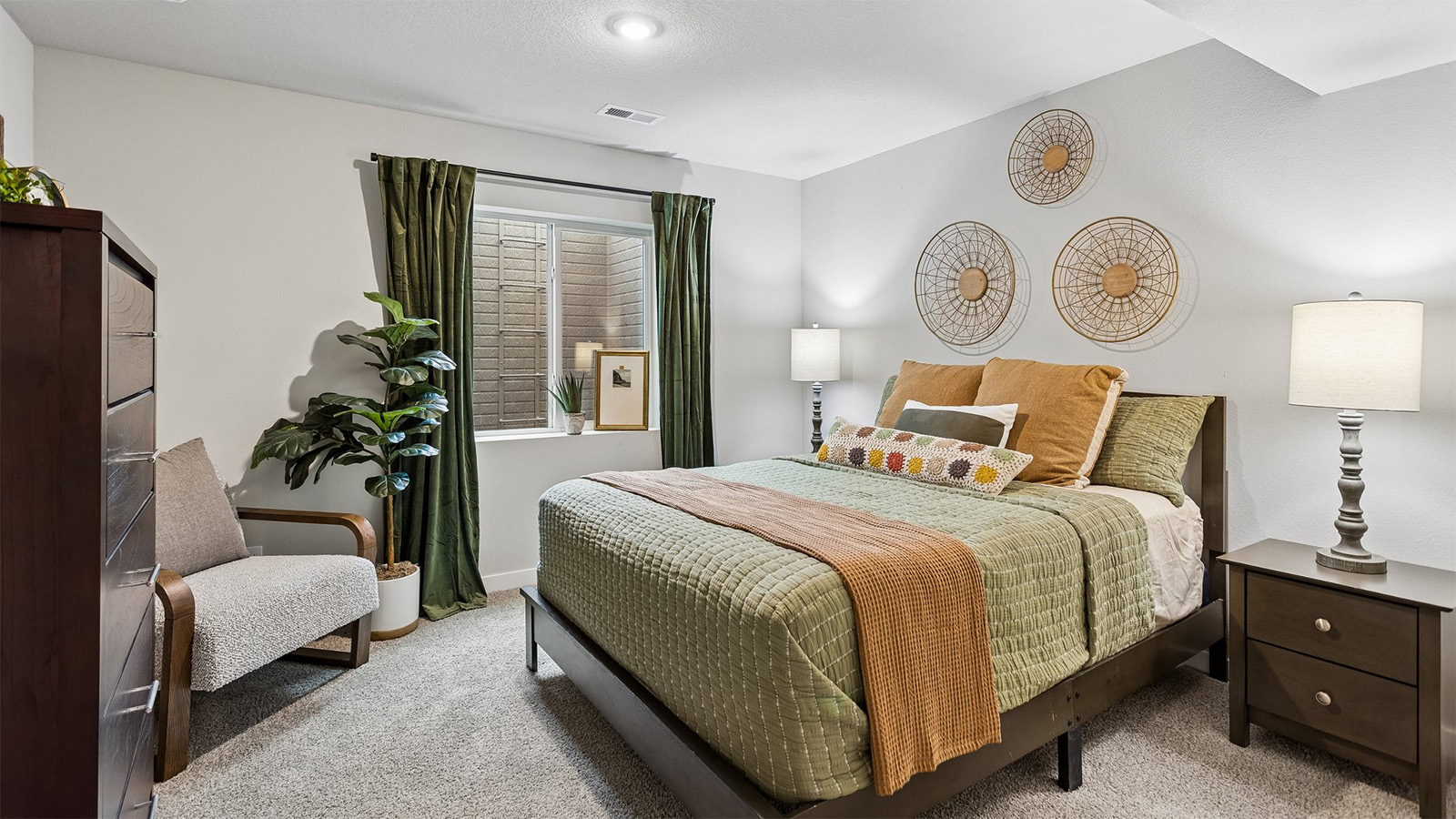 Fourth bedroom in the Abbott finished basement with queen bed and dresser