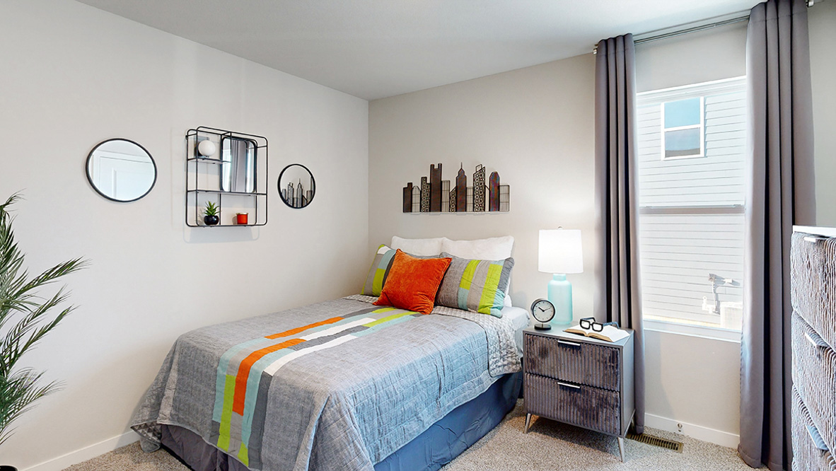 Second bedroom in the Abbott with a twin bed and window